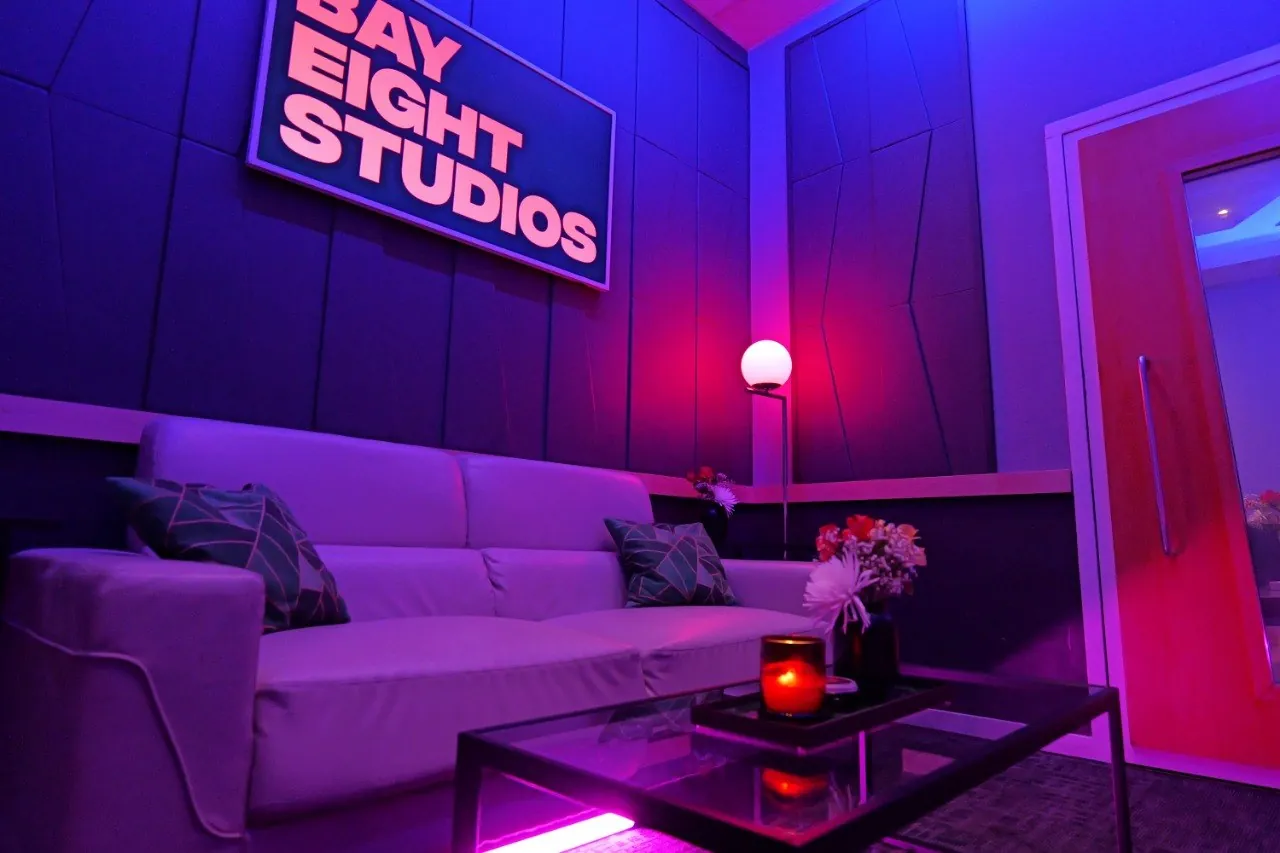 The SSL Room lounge at Bay Eight Studios, couch and Bay Eight sign