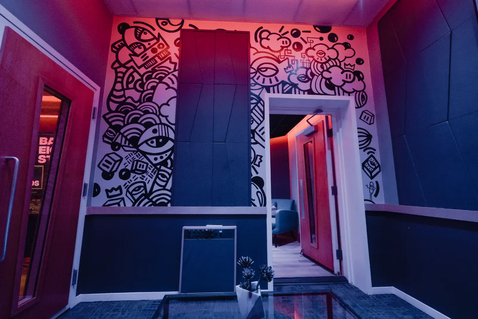 The mural wall and booth doorway in the SSL Room at Bay Eight Studios