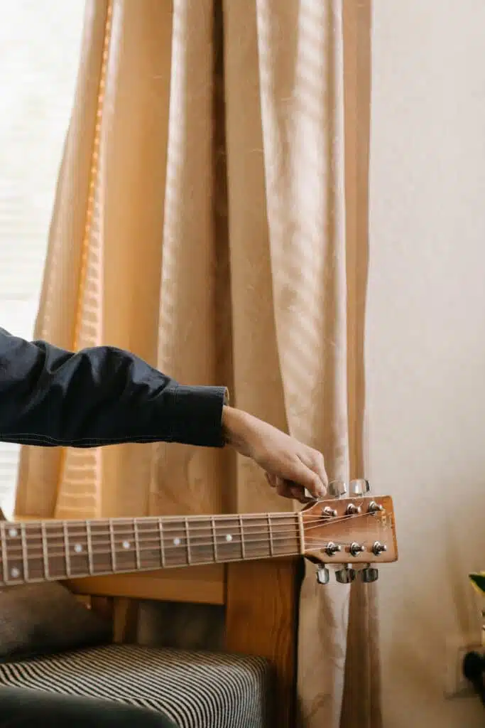 Hand tuning a guitar 