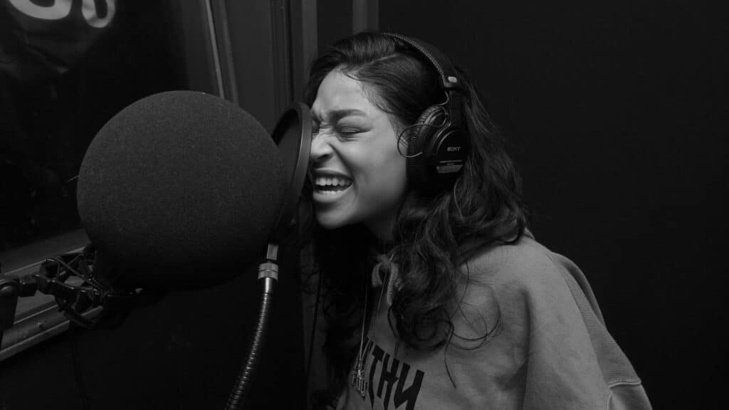 Miami Studio Woman in Gray Crew Neck Shirt Singing While Wearing Black Headphones Pexels Starter Cam 4387718