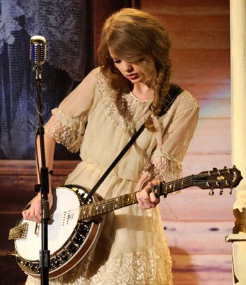 Taylor Swift playing banjo via Pinterest